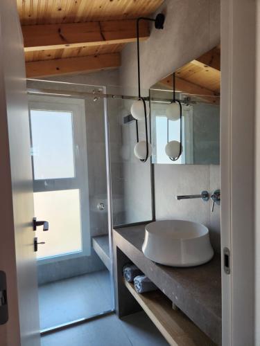 a bathroom with a sink and a mirror at Miranda Haus in Arillas