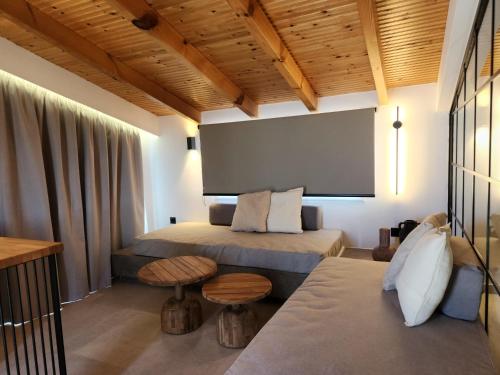 a room with two beds and a large screen at Miranda Haus in Arillas