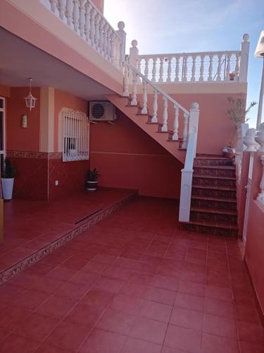 a staircase in a house with a red tile floor at COSTACABANA Apartamento in Almería