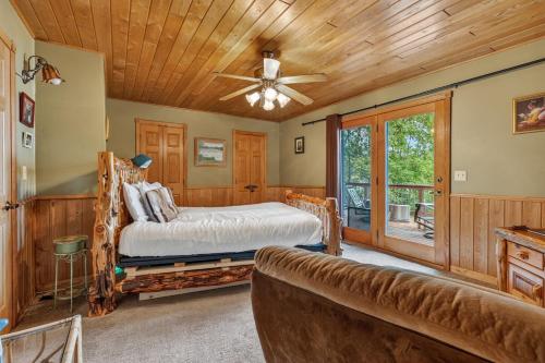 a bedroom with a bed and a ceiling fan at Next Chapter Family Retreat in Pequot Lakes