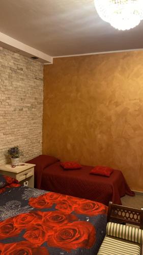 a bedroom with two beds with red sheets at B&b MAURO in Gioia Sannitica