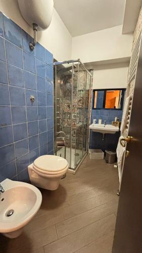 a bathroom with a toilet and a shower and a sink at B&b MAURO in Gioia Sannitica
