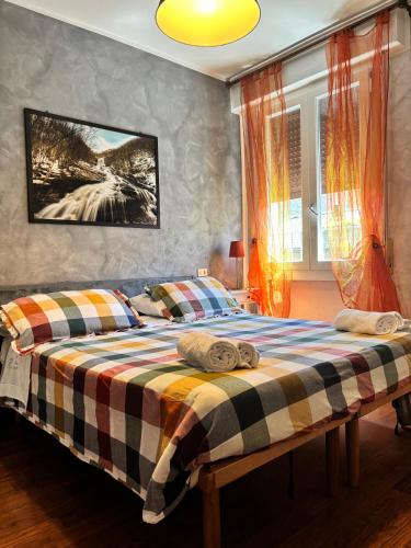 a bedroom with two beds and a tv on the wall at hotel Bologna in Fanano