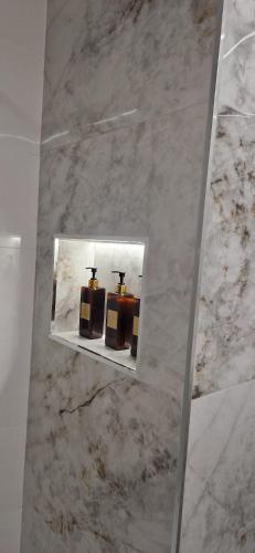 a mirror in a bathroom with two cakes on display at Devesa Park in Playa de Gandia