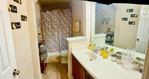 a bathroom with a sink and a shower at Trunks up! Spacious home ready for a fun time! in Lancaster