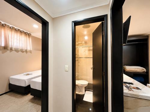 a bathroom with a toilet and a sink at Hotel Econotel by Bsb Inn in Brasília