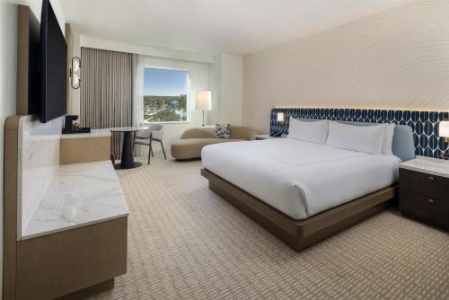 a hotel room with a large bed and a couch at Hilton Orlando in Orlando