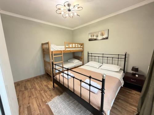 a bedroom with two bunk beds and a chandelier at The Lookout Grigoleti in Grigoleti
