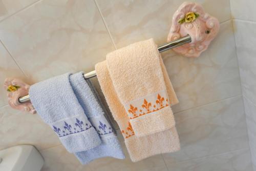 a couple of towels hanging on a towel rack in a bathroom at House H-ELIOS in Lovran