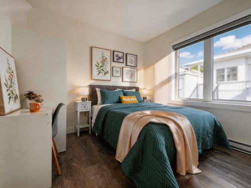 a bedroom with a bed and a large window at Vancouver Mandy Laneway Home in Vancouver