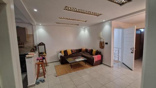 a living room with a couch and a table at Hostel the little prince in Tarfaya