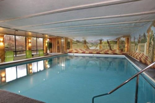 a large indoor swimming pool with a painting on the wall at Ferienwohnung Darosa Gipfelglück in Seeg