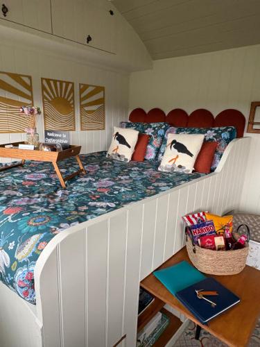 a bedroom with a large bed with penguins on it at Ledmacoy Shepherds Huts in Strathdon