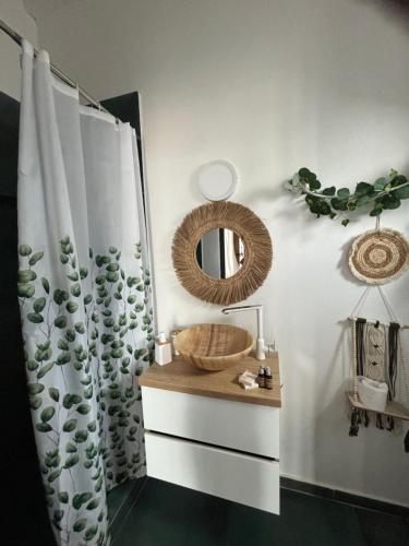 a bathroom with a shower curtain and a mirror at Beach Bungalows Costinesti in Costinesti