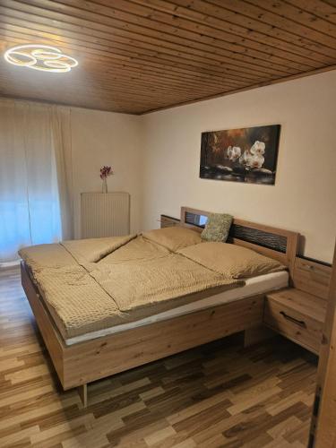 a bedroom with a large bed in a room at Ferienwohnung Langwallner in Grossarl