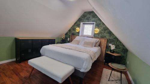 a bedroom with a large bed with a roof at Le Cosy Houdan in Goussainville