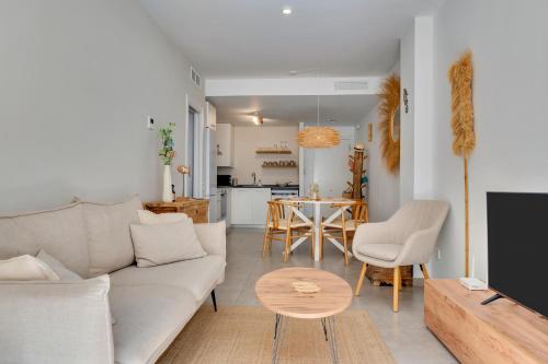a living room with a couch and a table at Bon Dia Moraira in Moraira