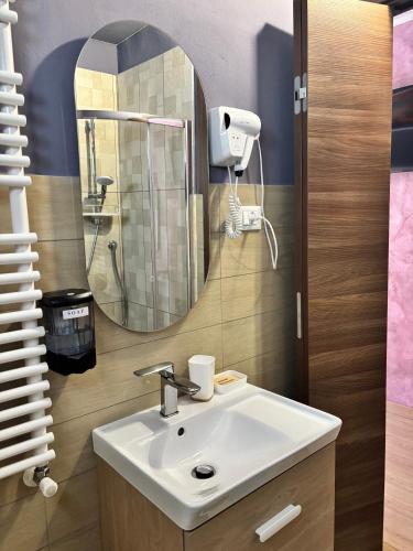 a bathroom with a sink and a mirror at hotel Bologna in Fanano