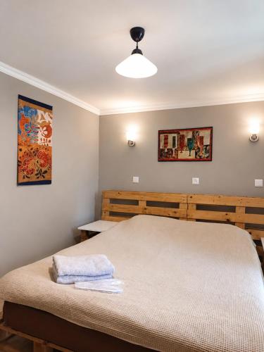 a bedroom with a large bed and a lamp at Welcome Guests in Tbilisi City