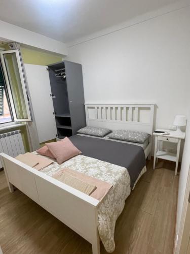 a bedroom with two beds and a desk and a window at La terrazza in Varazze