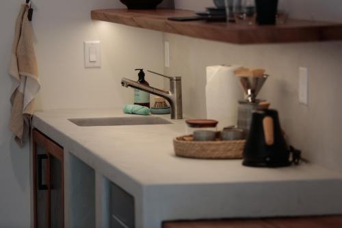 a kitchen counter top with a sink and a counter top at The Four Cedars in Ucluelet