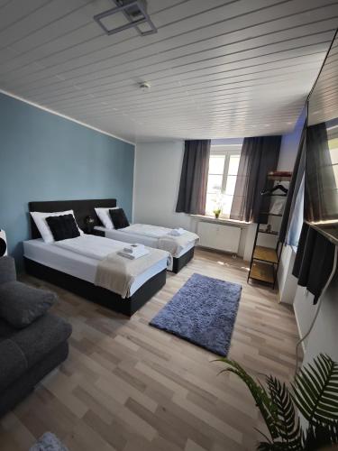 a bedroom with two beds and a couch at Monica Donau in Passau