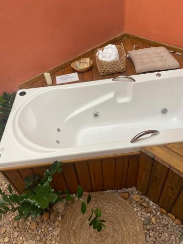 a white bath tub sitting in a bathroom at Pousada Viva Paraíso in Alto Paraíso de Goiás