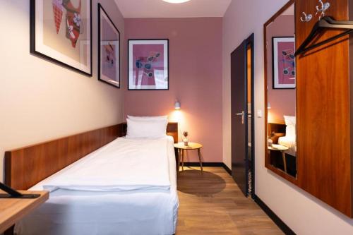 a bedroom with a white bed in a room at FLC 11 Rooms in Rødby