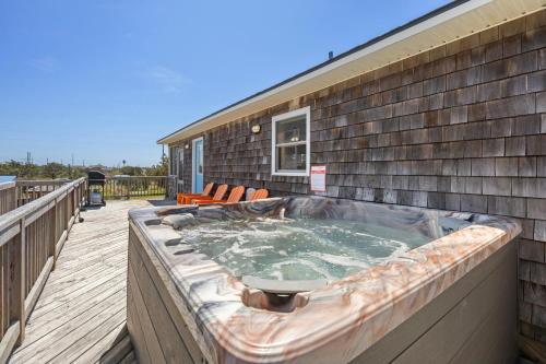 a hot tub on the deck of a house at 8055 - Down By The Dunes in Rodanthe