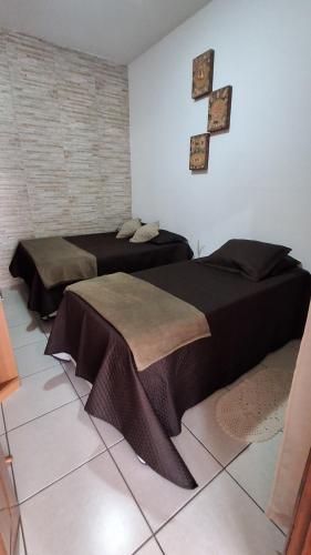 a room with two beds in a room at Santos & Oliveira in Diamantina