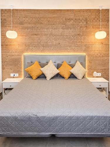 a bedroom with a large bed with yellow pillows at Veiw Luxury Apartment in Adeje