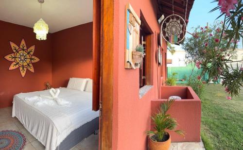 a bedroom with a bed in a house at Suítes icarai vila in Caucaia