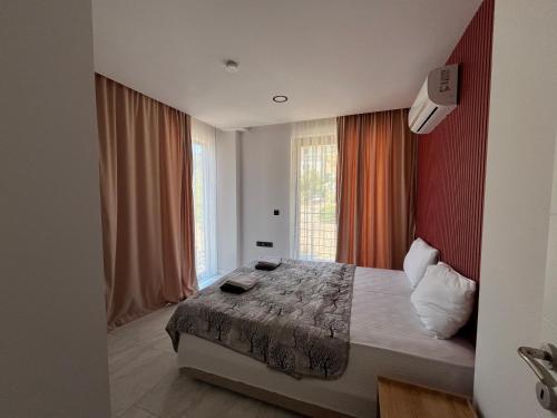 a bedroom with a bed and a large window at Villa Sunset in Marmaris