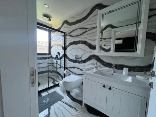 a bathroom with a toilet and a sink and a mirror at Villa Sunset in Marmaris