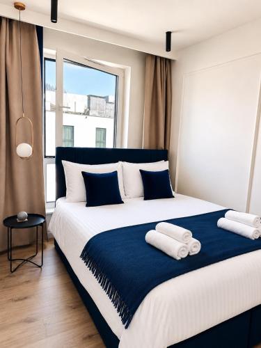 a bedroom with a large bed with two towels on it at Penthouse21 in Oświęcim