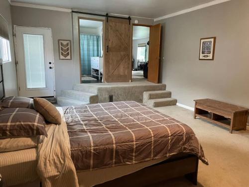a bedroom with a bed and a wooden table at Gravel Road Getaway in Hermiston