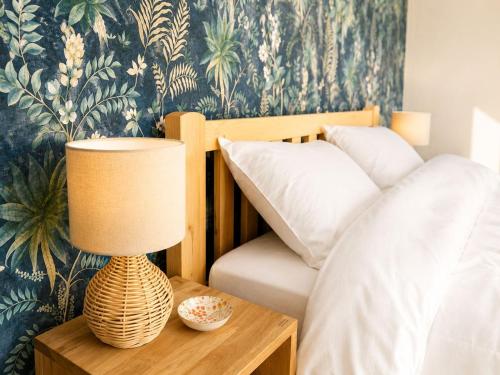 a bedroom with a bed and a lamp on a table at Panorama - Lake Maggiore House in Colazza