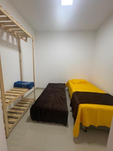 a bedroom with two beds next to a ladder at CASA COM PISCINA ATE 16 PESSOAS 700mts da praia do aracagy in São Luís