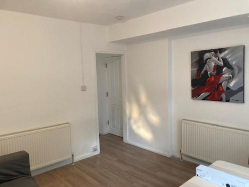 a living room with a painting on the wall at Chestnut Villa in Epsom