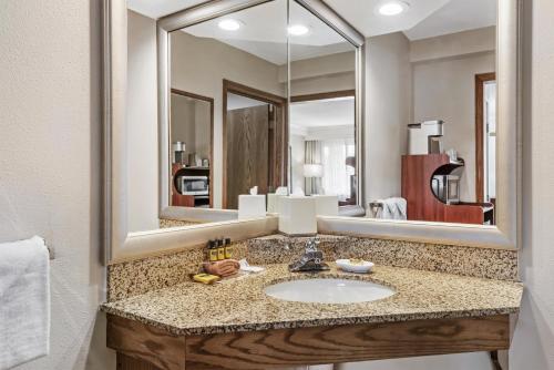 a bathroom with a sink and a large mirror at Best Western Plus Silver Saddle Inn in Estes Park