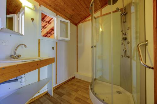 a bathroom with a shower and a sink at Comfortable chalet in a vacation village in Gujan-Mestras