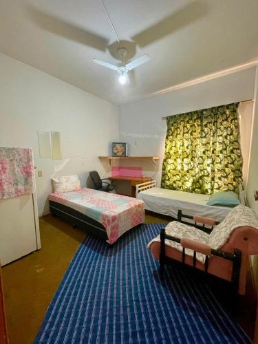 a room with two beds and a wall of bananas at POUSADA OCZ Centro1 in Osvaldo Cruz