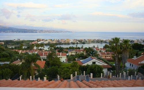 a view of a city with houses and the water at Sicily in Villa in Messina