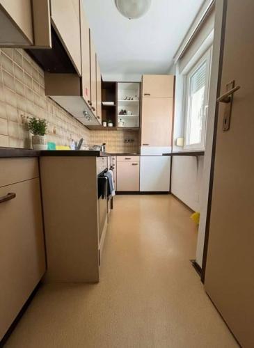 a kitchen with white cabinets and a counter top at Ruhig und gemütlich in Graz