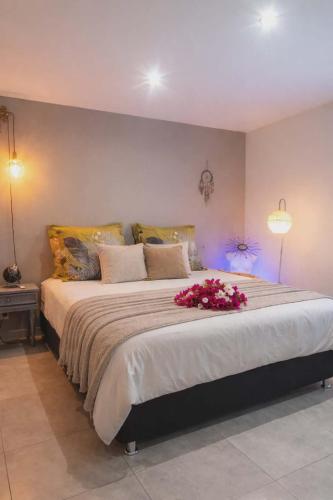 a bedroom with a large bed with flowers on it at La Kaz Sumac in Saint-Pierre