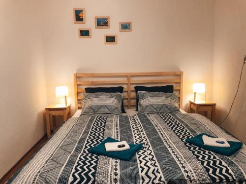 a bedroom with a large bed with blue towels on it at Chata Domaša - Monika in Holčíkovce