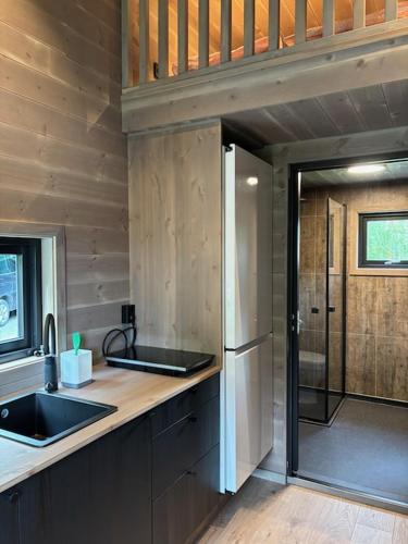 a kitchen with a sink and a refrigerator at Bjørgo Gard - Stegastein in Aurland