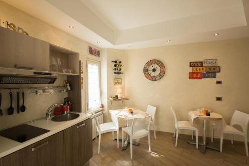 a kitchen with a table and chairs and a sink at Relais Tiburtina in Rome