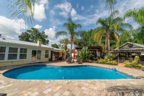 a swimming pool in front of a house at Saint Johns Oasis - Pool Hot Tub Grill in Jacksonville