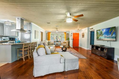 a living room with a couch and a kitchen at Saint Johns Oasis - Pool Hot Tub Grill in Jacksonville